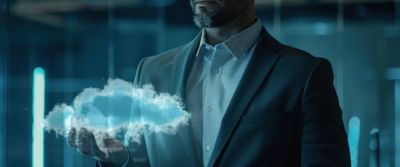 Man holds graphic of a cloud in hand, reflecting VMware cloud solutions expertise  | DXC Technology